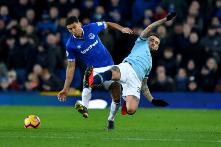 Manchester City's Nicolas Otamendi andEverton's Dominic Calvert-Lewin battle for the ball