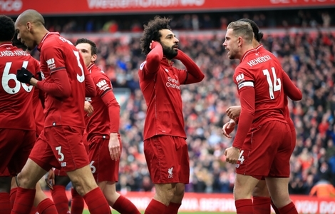Liverpool's Mohamed Salah (centre) celebrates scoring his side's second goal of the game with team-mates during the Premier League match at Anfield, Liverpool.